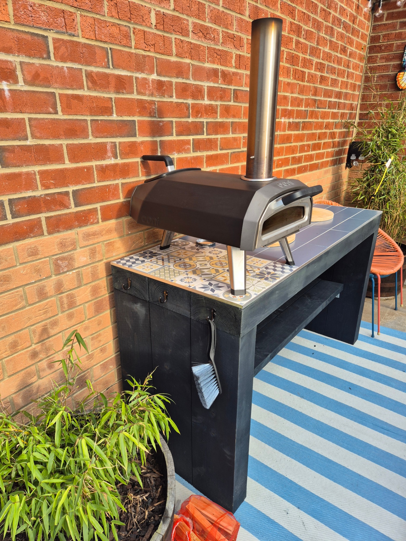 New build garden with fresh lawn, patio, fencing and borders, plus a custom timber pizza oven table